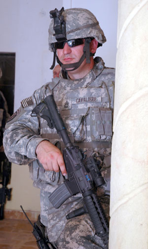 On watch: Sgt. 1st Class John Cavaliere, 2nd Brigade Combat Team personal security detachment noncommissioned officer in charge, guards a room the 2nd BCT commander and command sergeant major occupy during their visit to different areas of operation in Iraq. Cavaliere's job is to ensure the safety of 2nd BCT leaders. Photo by Staff Sgt. Angela McKinzie